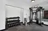 Contemporary fitness room equipped with a full set of dumbbells and a versatile cable machine, perfect for varied workouts.