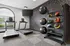 Modern fitness room with large windows, featuring state-of-the-art treadmills, stability balls, and colorful medicine balls, perfect for a healthy lifestyle.