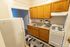 Charming kitchen featuring warm wooden cabinets, modern appliances, and a cozy ambiance perfect for culinary creations.