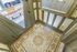 Elegant entryway featuring intricate mosaic tile flooring and classic panelled doors, exuding charm and sophistication.