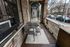 Charming urban balcony with cozy seating, perfect for enjoying city views and outdoor relaxation.