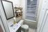 Elegant bathroom featuring modern vanity, stylish shelving, and ambient lighting for a serene retreat.