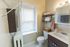 Charming bathroom with elegant shelving, neatly organized towels, and a bright, inviting atmosphere.
