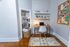 Charming home office nook with stylish desk, cozy lighting, and neatly organized bookshelves for inspiring productivity.