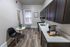 Chic modern kitchen with sleek cabinetry, stylish flooring, and cozy dining area perfect for culinary creativity.