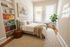 Bright and cozy bedroom featuring a stylish bed, vibrant bookshelf, and inviting natural light, perfect for relaxation and inspiration.