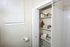 Charming bathroom featuring built-in shelves with neatly organized toiletries and plush towels, offering a cozy and inviting atmosphere.