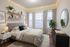 Inviting bedroom with cozy ambiance featuring elegant string lights, a stylish bed with patterned bedding, and sleek decor.