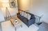 Cozy living area with a stylish gray sofa accented by decorative pillows, a modern coffee table with a succulent, elegant art, and a chic floor lamp setting a welcoming ambiance.