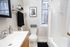 Bright and sophisticated bathroom featuring a modern sink, elegant wall art, and a refreshing blend of neutral tones.