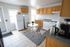 Bright and inviting kitchen with modern appliances, cozy dining area, and ample cabinetry for storage.