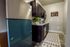 Modern kitchen with sleek dark cabinets, stainless steel appliances, and a cozy rug for an inviting touch.