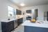 Bright, modern kitchen with sleek dark cabinets, stainless steel appliances, and a spacious island perfect for culinary adventures.