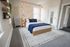 Charming bedroom with cozy bedding, soft lighting, and bohemian decor accents, offering a serene retreat.