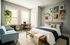 Elegant bedroom featuring a cozy bed with modern pillows, a charming gallery wall, and a light-filled workspace. Stylishly decorated with plants and soft furnishings for a serene atmosphere.