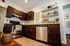 Charming kitchen with rich wooden cabinets, stainless steel appliances, and inviting decor, perfect for modern living.