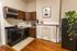 Charming kitchen with elegant cabinetry, modern appliances, and a cozy fireplace, perfect for stylish living.