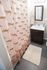 Chic bathroom featuring a playful leopard-print shower curtain, modern vanity, and cozy bath rug.