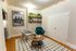 Charming living area with modern chairs, cozy rug, and elegant wall art in a Philadelphia-themed apartment.