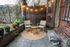 Charming garden patio with cozy seating, string lights, and lush plants, perfect for relaxing and entertaining.