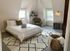 Charming attic bedroom with a cozy bed, modern decor, and ample natural light.