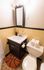 Charming bathroom with vintage tile, modern vanity, and a playful basketball-themed mat.