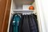 Cozy closet with a playful touch, featuring neatly hung coats and a basketball on the top shelf.