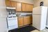Charming kitchen with modern appliances, sleek countertops, and ample cabinetry for storage.