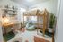 Charming bedroom with a cozy loft bed, stylish desk, and vibrant decor, ideal for a creative and inspiring living space.