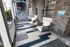 Charming porch with two modern chairs and a round table, perfect for enjoying a relaxing afternoon.