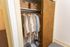 Inviting closet space showcasing organized hangers, stylish neutral clothing, and neat wicker storage baskets.