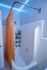 Modern bathroom featuring ambient LED lighting, a classic white bathtub, and vibrant orange shower curtain for a stylish touch.