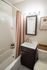 Cozy, modern bathroom with elegant vanity, framed mirror, and stylish shower curtain.