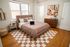 Inviting bedroom with a plush bed, stylish decor, and warm ambient lighting, offering a cozy retreat.