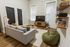 Chic and cozy living room with modern decor, featuring a comfortable sofa, stylish bean bag, sleek TV setup, and a unique wall of board games.