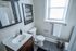 Chic modern bathroom featuring sleek fixtures, a stylish mirrored cabinet, and inspiring wall art for a refreshing start to your day.