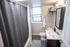 Chic bathroom featuring a sleek vanity, modern fixtures, and soft ambient lighting, creating a refreshing retreat.