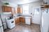 Charming kitchen with warm wooden cabinets, a cozy gas stove, and bright natural light accentuating the inviting space.