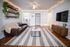 Inviting living room with a cozy brown leather sofa, modern decor, and ambient string lights creating a warm atmosphere.
