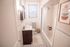 Bright and cozy bathroom with elegant hexagonal tiles, a sleek vanity, and stylish wall art. Ideal blend of functionality and modern design.