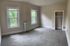 Bright and airy bedroom with lush green views, plush carpeting, and a walk-in closet, offering serene comfort and style.