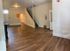 Spacious and inviting open-concept living area with elegant wood flooring and modern design.