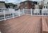 Charming rooftop deck with white railing, perfect for relaxing and enjoying city views.
