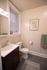 Elegant bathroom featuring a sleek vanity, modern fixtures, and tasteful wall art, ideal for contemporary living.