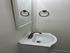 Chic modern bathroom with sleek mirror, elegant faucet, and minimalist towel holder.