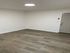 Bright and airy room featuring elegant wood flooring and a modern ceiling light, perfect for personalized interiors.