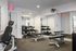 Modern fitness center with sleek equipment, mirrored walls, and natural light, perfect for an energizing workout.