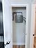 Efficient home utility closet showcasing a modern tankless water heater, optimizing space and energy usage.