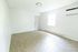 Bright and airy living space featuring modern wood flooring, large window for natural light, and sleek wall-mounted air conditioning unit.