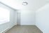 Bright, minimalist room with modern wood flooring and ample natural light.